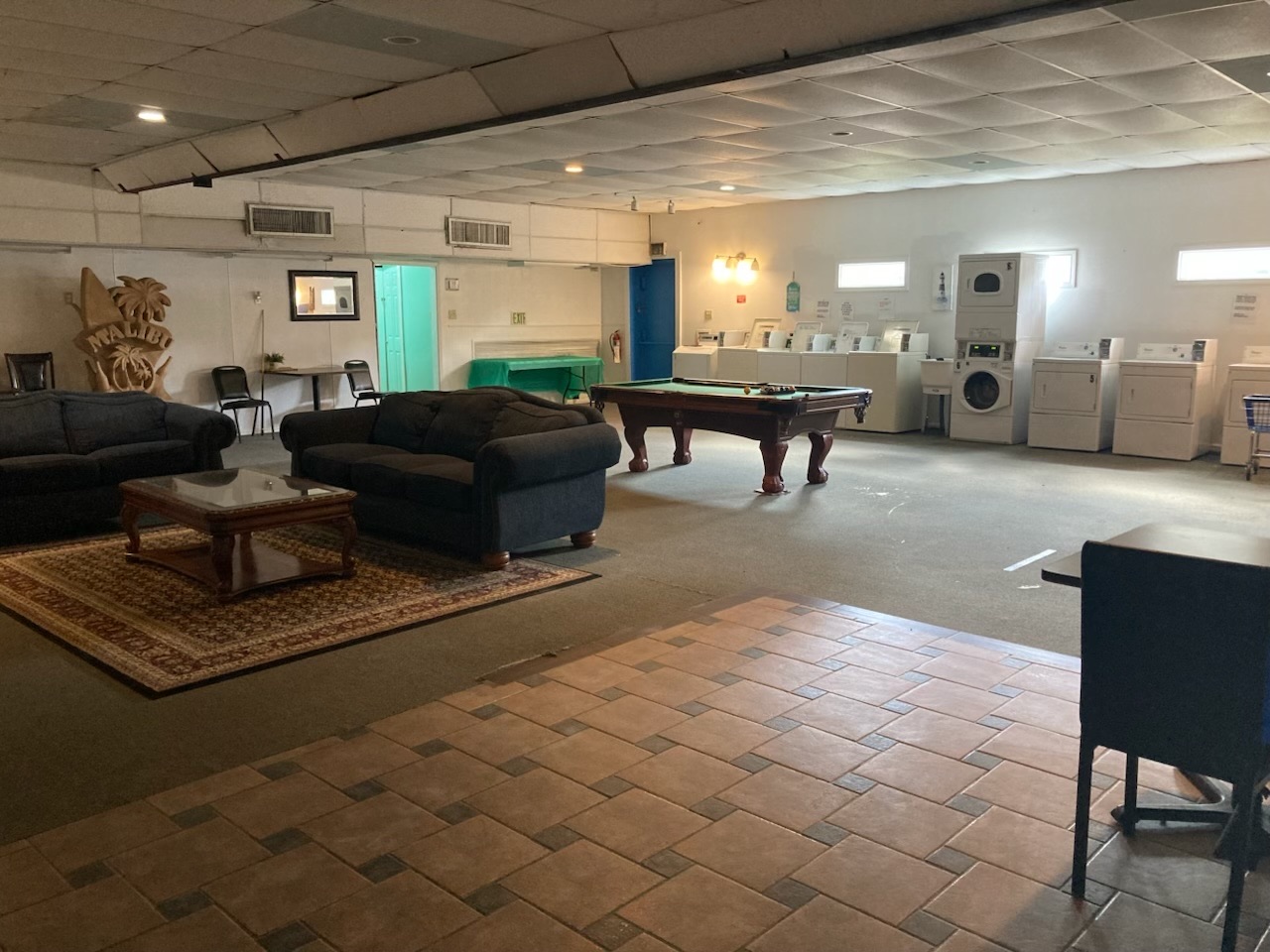 Lounge and laundry room with pool table and seating